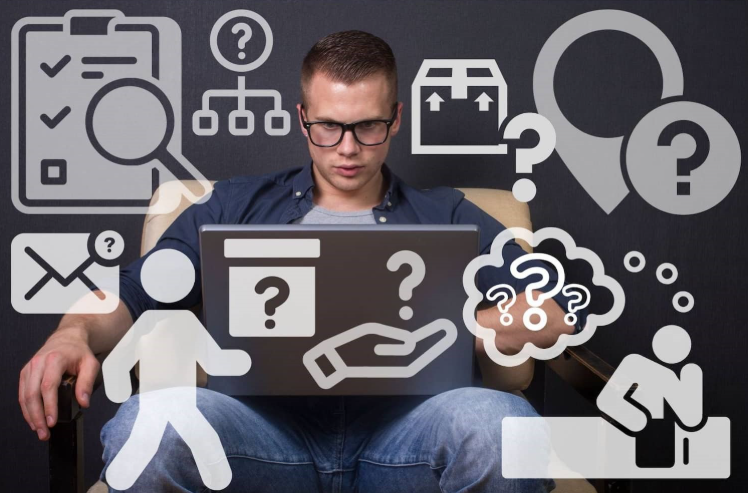 A man with laptop surrounded with various question icons 