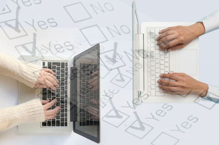 Two people doing the survey on their laptops 