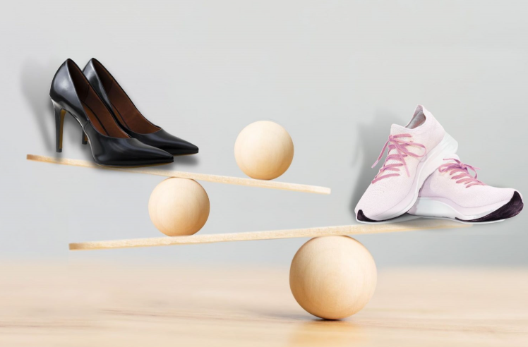 Business shoes and sports sneakers balancing on the sea-saw