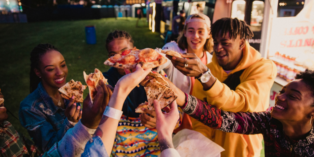 Friends trying food at a food truck festival