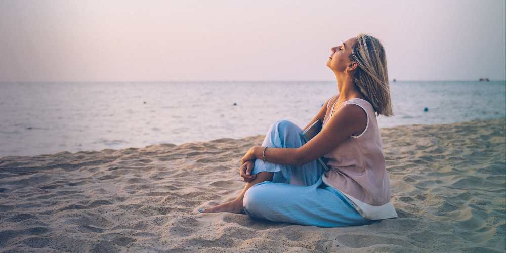 A woman relaxes on a beach