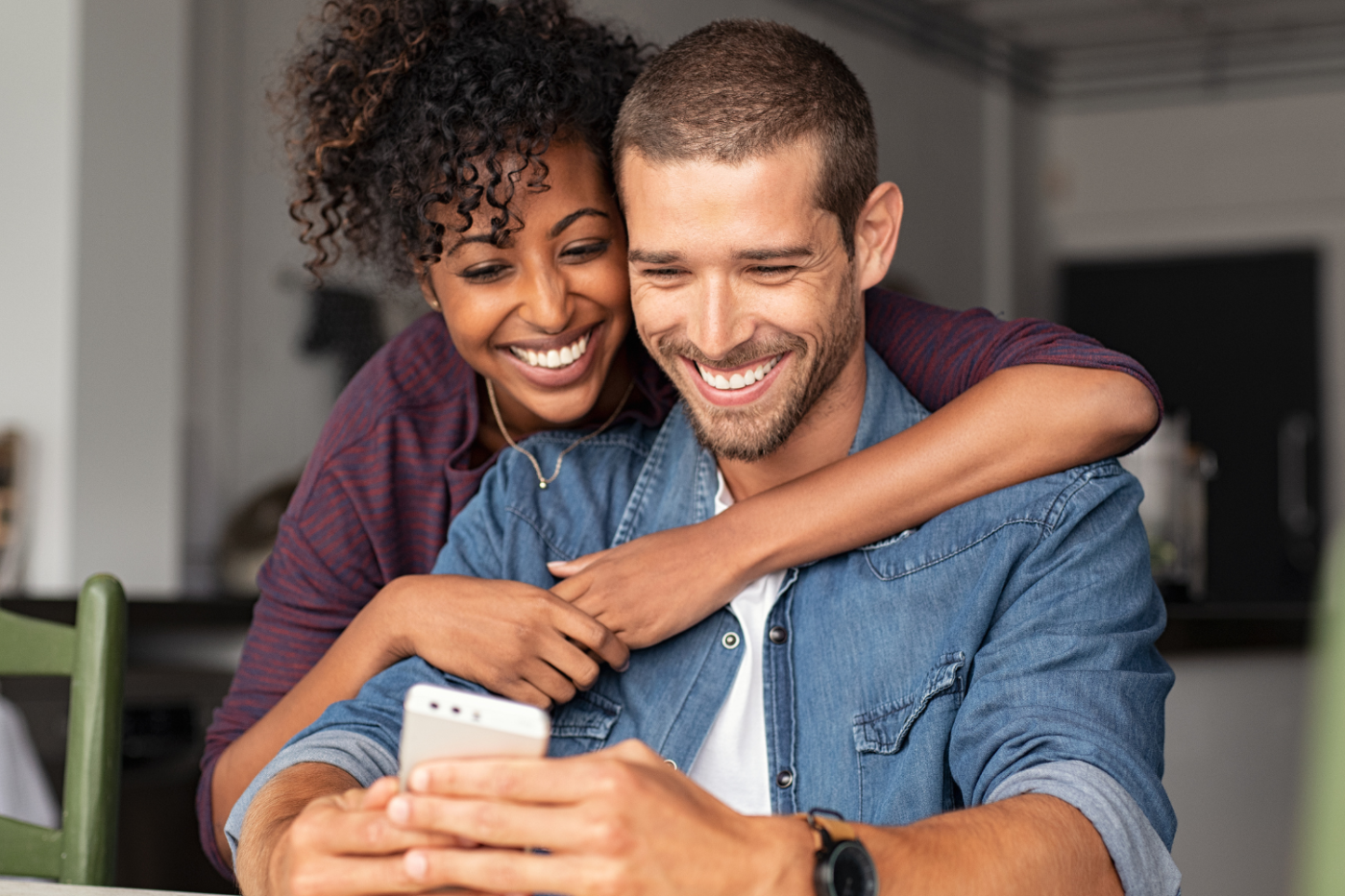 man and woman smiling at a phone