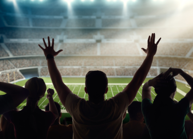 Fans cheer at a football stadium