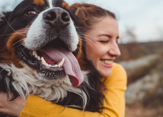 A woman hugs her dog