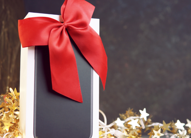 A new smartphone in a box with a red bow