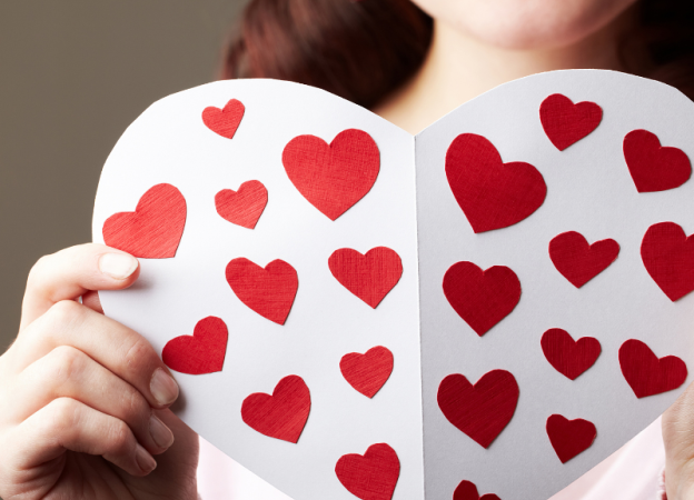 A woman hold a homemade Valentine's Day card