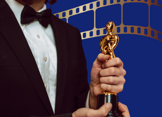 A man holding an Oscar statue