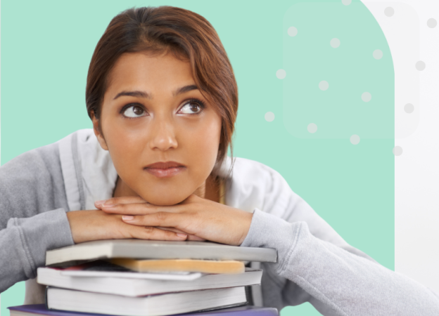 A high school student rests her chin on a stack of books and thinks about her future